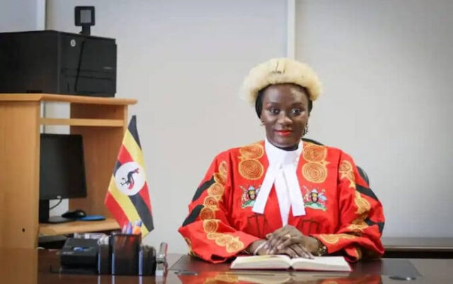 Lydia Mugambe, a UN judge and Ugandan High Court official, is accused of luring a young Ugandan woman to the UK under false pretenses.