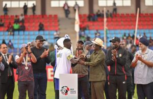 Kenya Police FC Lift League Trophy After Thrilling FKF-PL Finish Kenya Police FC clinch their first-ever FKF Premier League title Held Gor Mahia to a 1-1 draw on final day to wrap up dominant season Luxury cars, stylish suits, and top dignitaries graced title coronation Club rose from early season struggles to unstoppable form under new coach Will now represent Kenya in 2025/26 CAF Champions League Police Crowned Kings of Kenyan Football The 2024/25 FKF Premier League season wrapped up in style as Kenya Police FC wrote history, lifting the title for the very first time. The law enforcers held Gor Mahia to a 1-1 draw on Sunday at the Ulinzi Sports Complex, confirming their place at the top with 65 points. What started as an ordinary campaign turned into a memorable fairytale — powered by new leadership, raw determination, and a team that refused to give up. Stylish Entry, Royal Finish Dressed like champions even before kickoff, the Police players arrived at the stadium in a convoy of Mercedes-Benz cars and a limousine. They rocked matching blue suits, red ties, and white sneakers, drawing attention even before the action began. The grand finale drew in big names — from Raila Odinga to Interior CS Kipchumba Murkomen, PS Raymond Omollo, and DIG Gilbert Masengeli. The event also welcomed Mike Sonko, McDonald Mariga, and club chairman Nyale Munga. The newly designed FKF trophy was handed over by former Harambee Stars legend George Sunguti, as fans cheered the club’s first-ever league triumph. Gor Mahia Give Guard of Honour In a rare show of sportsmanship, Gor Mahia players formed a guard of honour for their rivals. Gor struck first in the 24th minute through Shariff Musa, but David Okoth equalized with a calm finish in the 56th minute, sealing the draw. Even though the result didn’t affect the table, it was a reminder of the fight and pride that carried Police all season. The title had already been secured a week earlier after Police edged Shabana FC 1-0 in Machakos. That win took them to an unreachable lead — and Sunday’s draw simply added polish to a golden run. From Slow Starters to Record Breakers Police FC’s story is one of patience, faith, and a powerful turnaround. Formed in 2014 and only promoted to the Premier League in 2021, the club’s early days were marked by struggle. This season began just as poorly, with only one win in their first eight games. But things turned after the club hired Burundian coach Etienne Ndayiragije on November 29, 2024. Although he lost his debut match to AFC Leopards, what followed was magical — 13 matches unbeaten, including 10 wins and 3 draws. Police ended the season with 18 wins, 11 draws, and just 5 defeats — an impressive turnaround from mid-table mediocrity to champions. A Captain’s Tears, A Nation’s Applause Veteran defender and captain David “Cheche” Ochieng’ couldn’t hold back tears after lifting the trophy — his first in 13 years, since winning the title with Tusker FC in 2012. “This is all God. I’ve waited long for this. I dedicate this win to my mother — our strongest pillar,” said a deeply moved Ochieng’. Coach Ndayiragije also praised his players and staff for showing resilience and discipline through the tough stretches. Eyes on Africa Now With the league now in the bag, Kenya Police FC will shift focus to the CAF Champions League, set to begin in the 2025/26 season. This marks their debut on the continental stage — a major leap for a club that, not long ago, was struggling to stay afloat. From luxury limousines to gritty comebacks, Police FC’s season had it all. And now, they march into Africa not just with medals — but with a statement. The new sheriffs of Kenyan football have arrived.