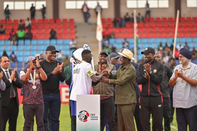 Kenya Police FC clinch their first-ever FKF Premier League title Held Gor Mahia to a 1-1 draw on final day to wrap up dominant season Luxury cars, stylish suits, and top dignitaries graced title coronation Club rose from early season struggles to unstoppable form under new coach Will now represent Kenya in 2025/26 CAF Champions League Police Crowned Kings of Kenyan Football The 2024/25 FKF Premier League season wrapped up in style as Kenya Police FC wrote history, lifting the title for the very first time. The law enforcers held Gor Mahia to a 1-1 draw on Sunday at the Ulinzi Sports Complex, confirming their place at the top with 65 points. What started as an ordinary campaign turned into a memorable fairytale — powered by new leadership, raw determination, and a team that refused to give up. Stylish Entry, Royal Finish Dressed like champions even before kickoff, the Police players arrived at the stadium in a convoy of Mercedes-Benz cars and a limousine. They rocked matching blue suits, red ties, and white sneakers, drawing attention even before the action began. The grand finale drew in big names — from Raila Odinga to Interior CS Kipchumba Murkomen, PS Raymond Omollo, and DIG Gilbert Masengeli. The event also welcomed Mike Sonko, McDonald Mariga, and club chairman Nyale Munga. The newly designed FKF trophy was handed over by former Harambee Stars legend George Sunguti, as fans cheered the club’s first-ever league triumph. Gor Mahia Give Guard of Honour In a rare show of sportsmanship, Gor Mahia players formed a guard of honour for their rivals. Gor struck first in the 24th minute through Shariff Musa, but David Okoth equalized with a calm finish in the 56th minute, sealing the draw. Even though the result didn’t affect the table, it was a reminder of the fight and pride that carried Police all season. The title had already been secured a week earlier after Police edged Shabana FC 1-0 in Machakos. That win took them to an unreachable lead — and Sunday’s draw simply added polish to a golden run. From Slow Starters to Record Breakers Police FC’s story is one of patience, faith, and a powerful turnaround. Formed in 2014 and only promoted to the Premier League in 2021, the club’s early days were marked by struggle. This season began just as poorly, with only one win in their first eight games. But things turned after the club hired Burundian coach Etienne Ndayiragije on November 29, 2024. Although he lost his debut match to AFC Leopards, what followed was magical — 13 matches unbeaten, including 10 wins and 3 draws. Police ended the season with 18 wins, 11 draws, and just 5 defeats — an impressive turnaround from mid-table mediocrity to champions. A Captain’s Tears, A Nation’s Applause Veteran defender and captain David “Cheche” Ochieng’ couldn’t hold back tears after lifting the trophy — his first in 13 years, since winning the title with Tusker FC in 2012. “This is all God. I’ve waited long for this. I dedicate this win to my mother — our strongest pillar,” said a deeply moved Ochieng’. Coach Ndayiragije also praised his players and staff for showing resilience and discipline through the tough stretches. Eyes on Africa Now With the league now in the bag, Kenya Police FC will shift focus to the CAF Champions League, set to begin in the 2025/26 season. This marks their debut on the continental stage — a major leap for a club that, not long ago, was struggling to stay afloat. From luxury limousines to gritty comebacks, Police FC’s season had it all. And now, they march into Africa not just with medals — but with a statement. The new sheriffs of Kenyan football have arrived.