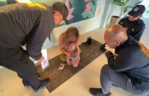 Woman Arrested for Running ‘Sex Yoga’ Sessions Behind Restaurant A 40-year-old Russian woman, Maria Shchetinina, was arrested for running unlicensed tantric sessions. Police raided the venue after complaints about “sexually indecent” online promotions. She allegedly violated Thailand’s foreign employment laws by working outside her permit. Authorities confiscated teaching materials and promotional items for investigation. The arrest mirrors another similar case on the island earlier this year. Arrest Over Tantric Lessons A Russian national, Maria Shchetinina, also known as Maria Sly Love, has been arrested in Koh Phangan after authorities accused her of running weekly tantric classes for tourists. The sessions, held behind the Ethos restaurant, reportedly cost 400 baht and included meditation, tantric massage, and what she described as “sacred sexuality.” How Police Intervened Police officers raided the area on 4 November following complaints about online adverts that residents considered inappropriate. Body-camera footage captured officers entering the room while a class was underway, with students seated cross-legged on yoga mats as Shchetinina led the session. During the inspection, officers reviewed her passport and work permit, which listed her occupation as a customer relations manager for a property management company. Authorities said the activities she was performing were outside the scope of her authorised work. Charges and Seized Materials Police Lieutenant Colonel Winit Boonchit confirmed that the suspect was charged with working illegally and conducting classes without official permission. She was taken to Koh Phangan Police Station for further questioning. Investigators also seized her notebooks, flyers, enrolment slips, and promotional materials featuring her photo and QR code—items used to market the sessions to tourists. Growing Concern Over Similar Activities Officials say the case was triggered by rising concerns from locals about “risque” social media promotions targeting visitors. The incident comes months after a Polish YouTuber was also arrested for organising “sex yoga” lessons on the same island. A Popular Hub for Spiritual Tourism Koh Phangan, known globally for its relaxed atmosphere, spiritual retreats, and vibrant nightlife, continues to attract yoga lovers, backpackers, and festival-goers. However, authorities are now paying closer attention to activities that may breach cultural norms or violate Thailand’s strict employment laws.